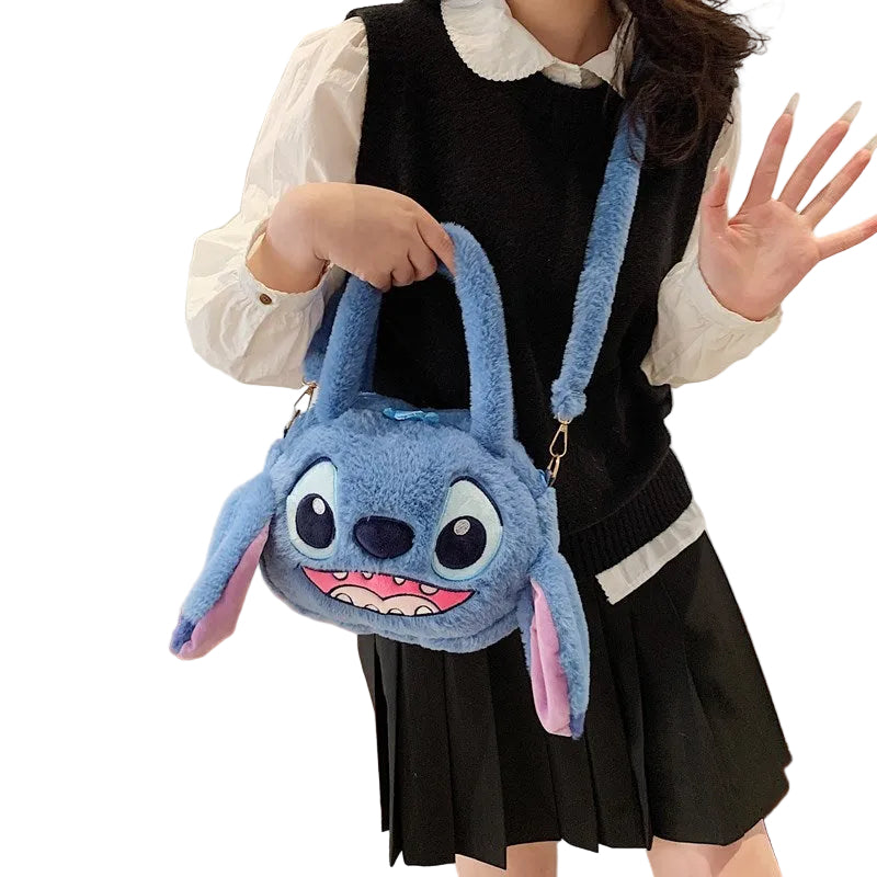 Person holding a blue plush bag resembling a cartoon character, standing in a room.