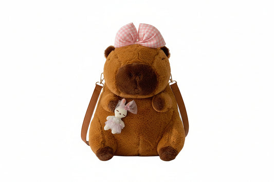 Brown plush backpack with a bear design and pink checkered hat on a white background