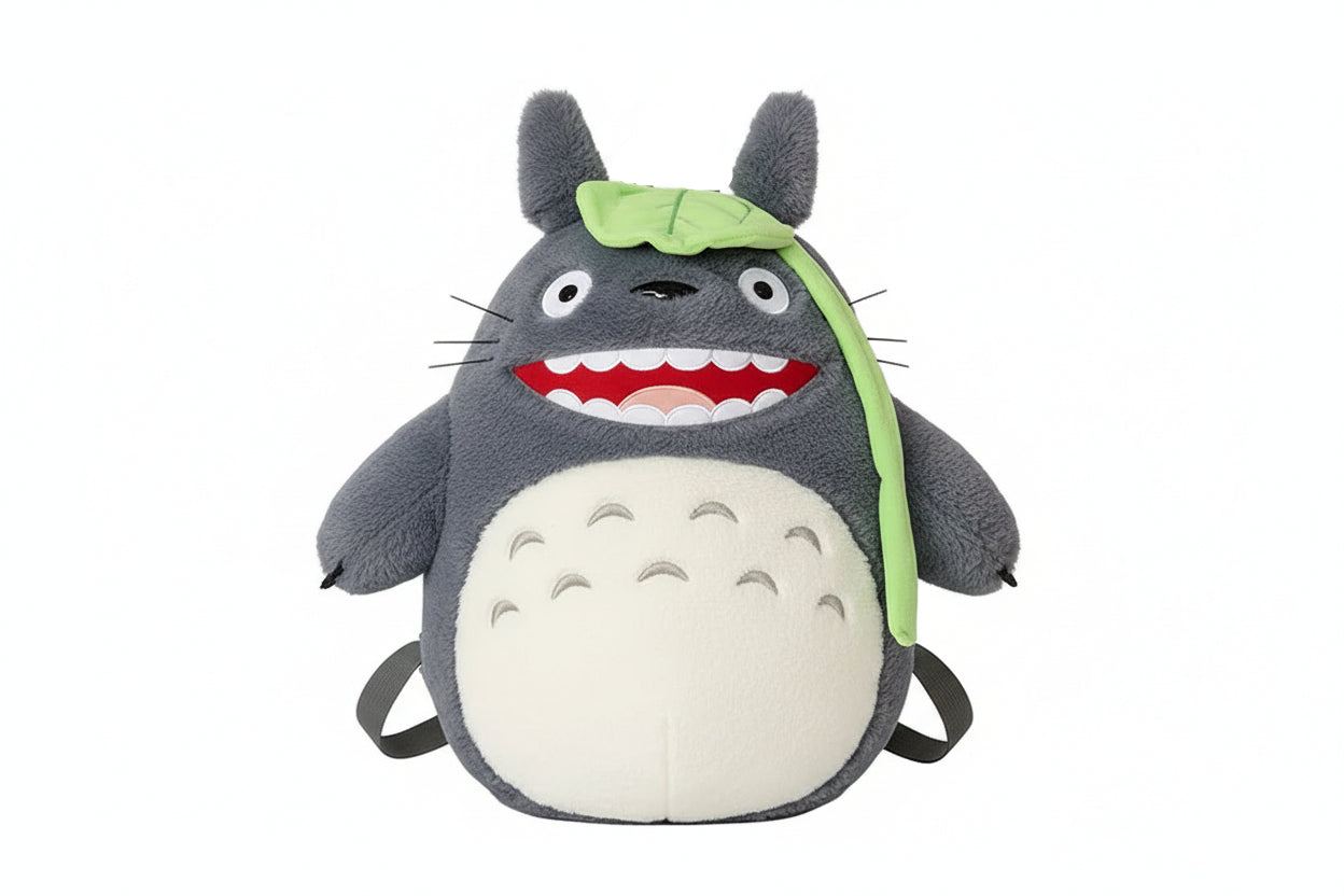 Plush toy resembling a character with a green leaf on its head against a white background