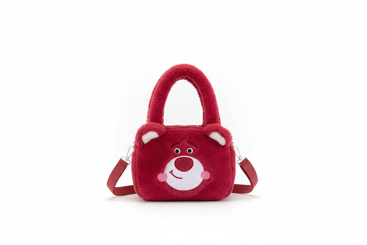 Red plush bag with a bear face design on a white background