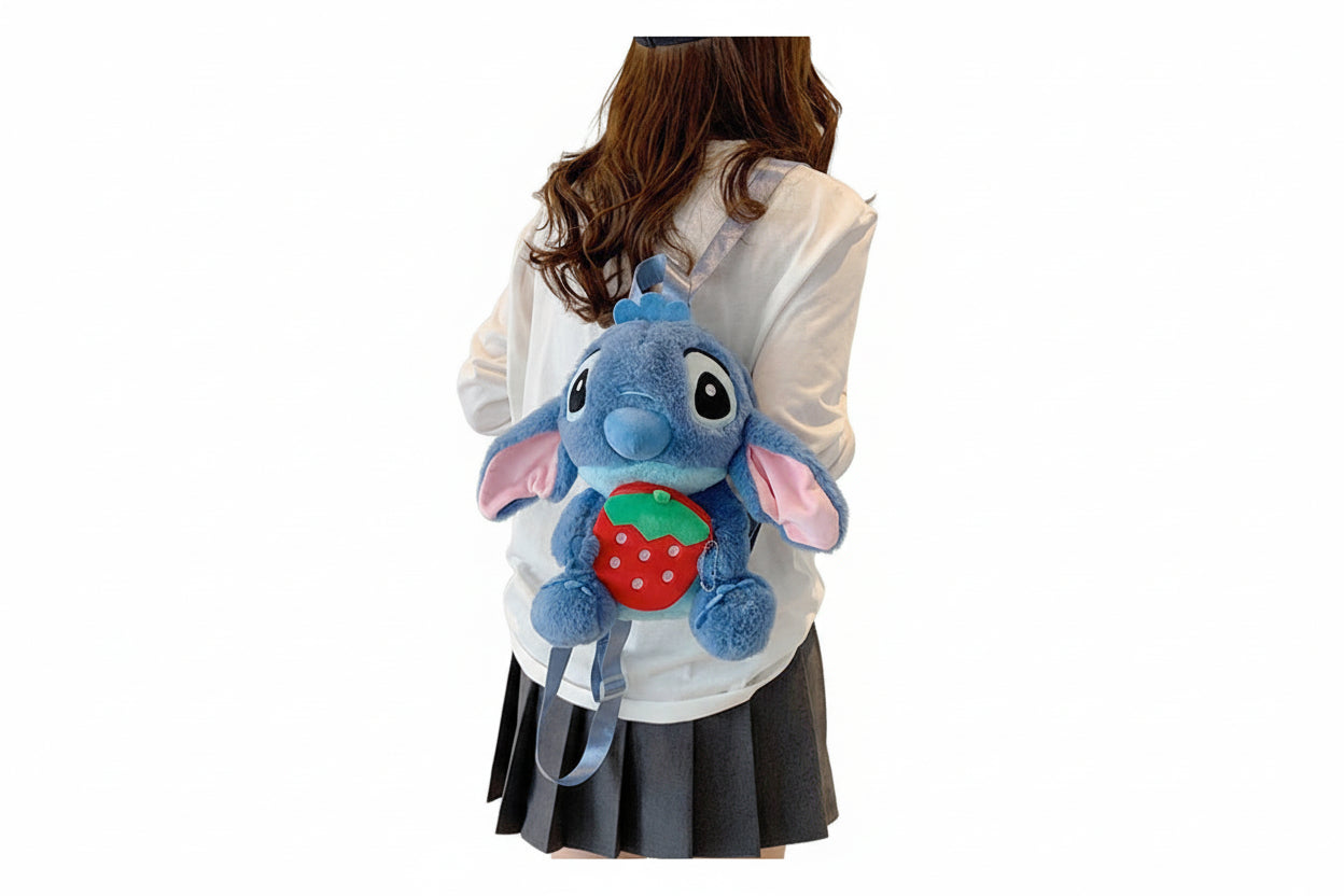 Blue plush toy with a strawberry on a white background