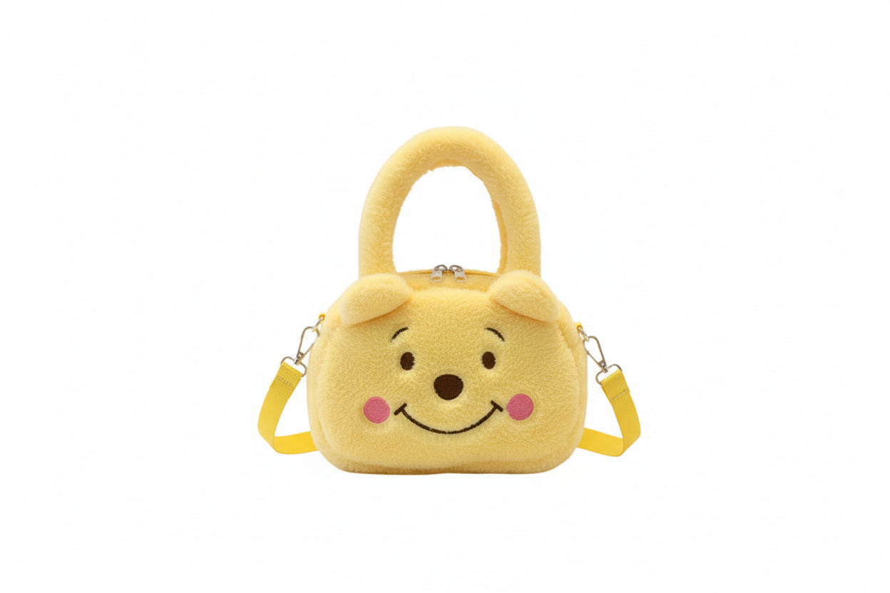 Yellow plush bag with a bear face design on a white background