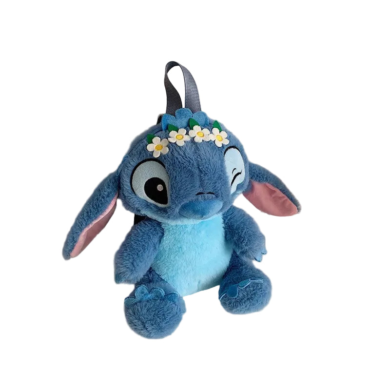 Blue plush toy with flower headband on a white background