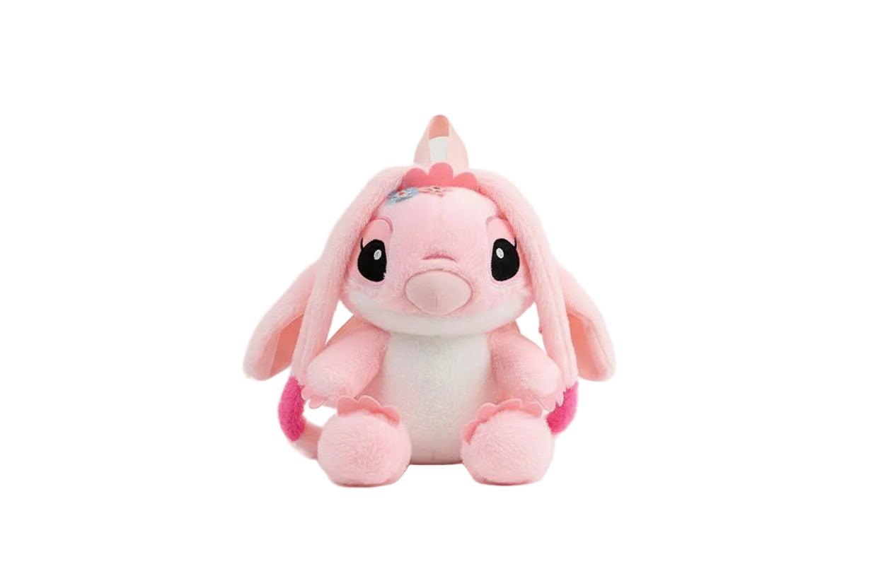 Pink and white plush toy with black eyes on a white background