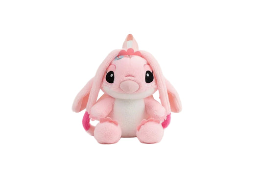 Pink and white plush toy with black eyes on a white background