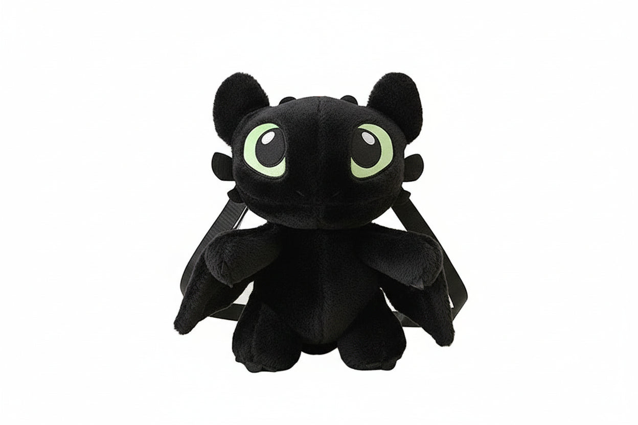 Person holding a black dragon-shaped backpack with green eyes in a room.
