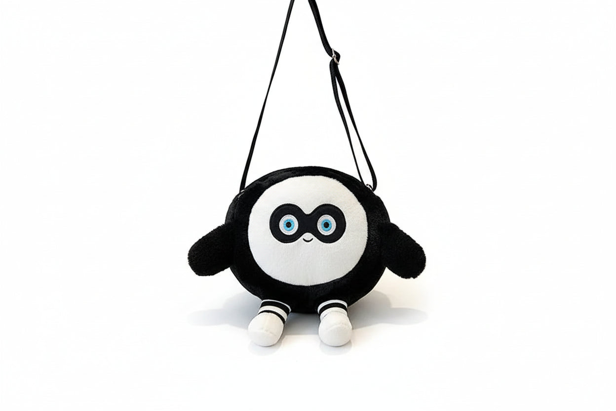 Black and white plush toy with a round face and striped legs on a white background