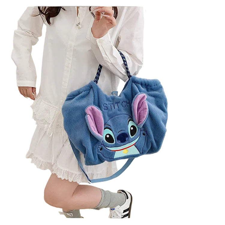 Blue plush bag with a character design on a white background