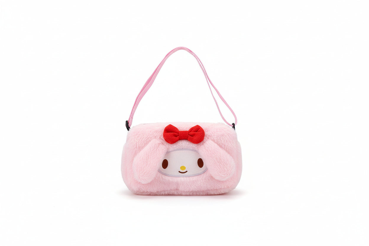 Pink plush eye mask with a cartoon face and red bow on a white surface.