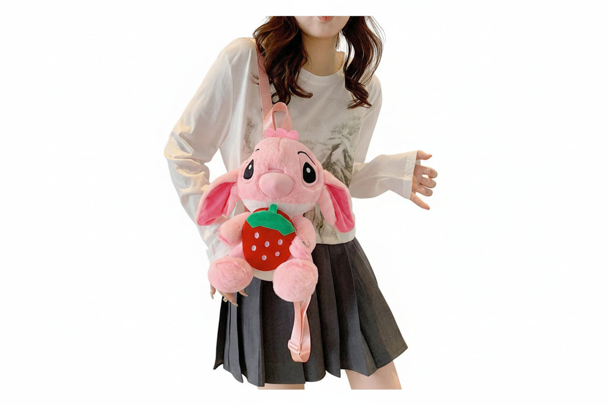Plush toy shaped like a pink rabbit with a strawberry on a white background